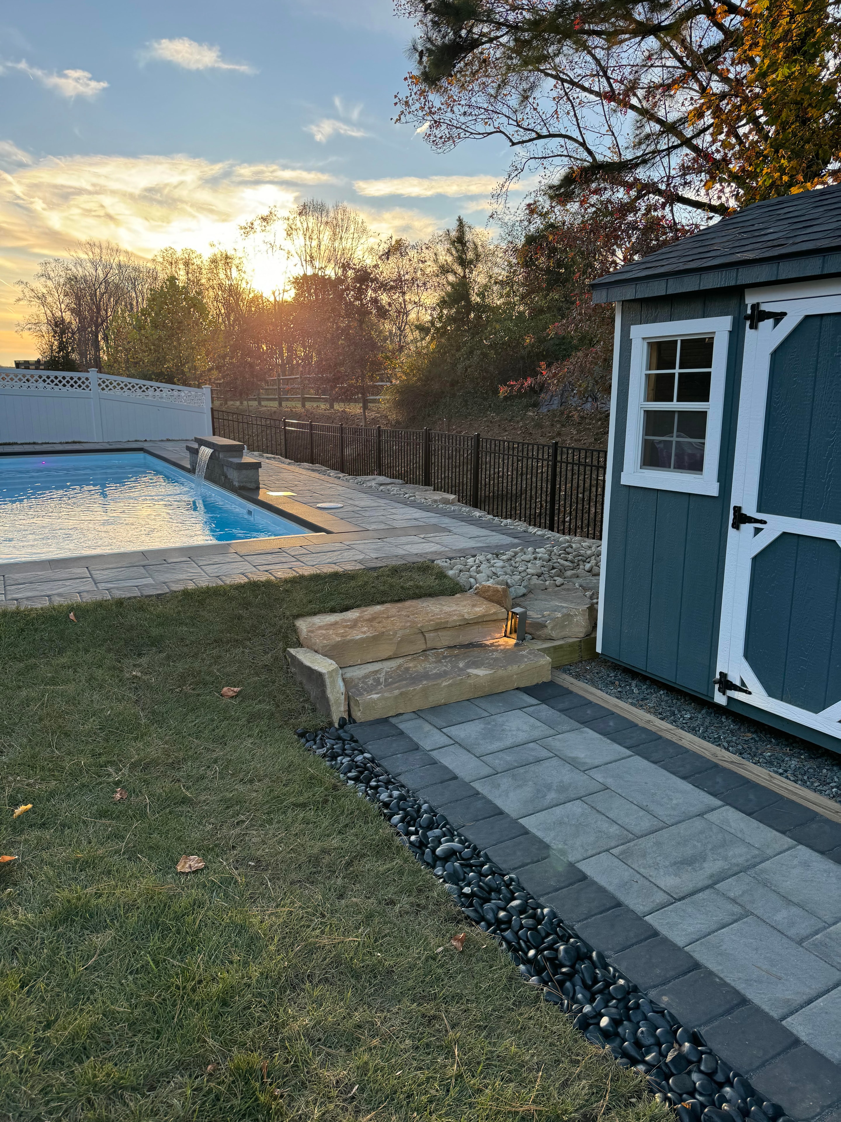 LandPro pool with paver patio and waterfall feature