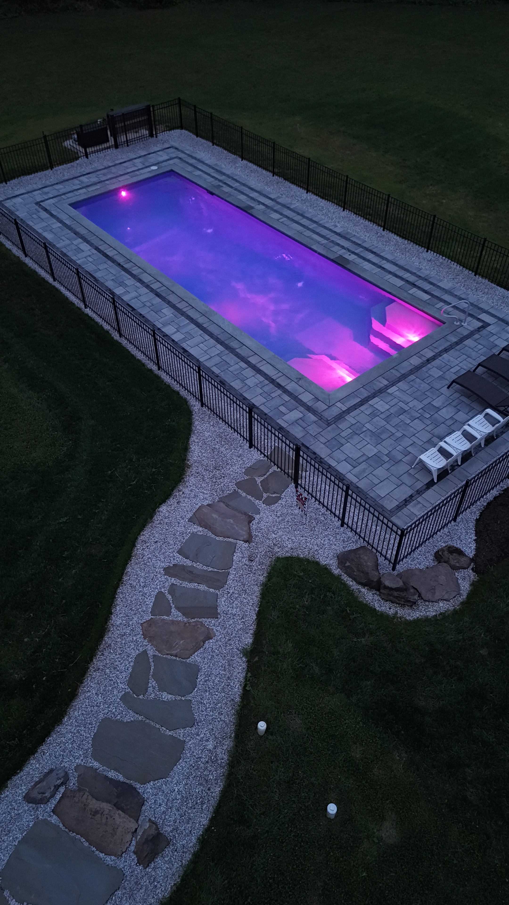 Country Oasis — aerial view of pool with purple LED lighting and stone walkway