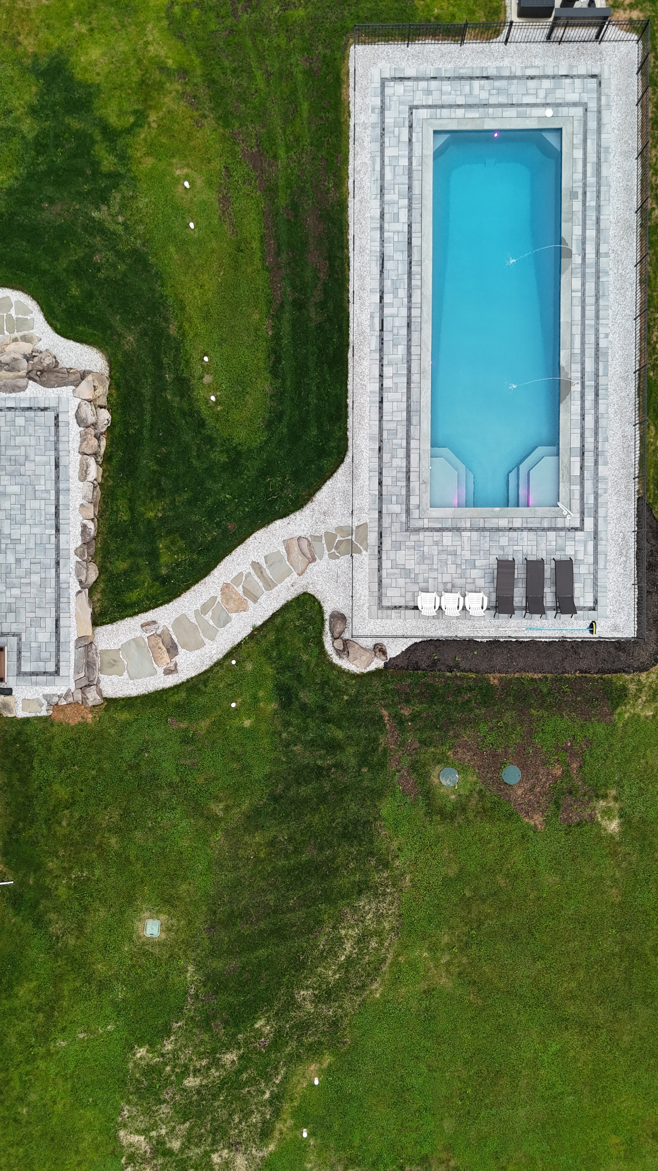 Country Oasis — overhead aerial of pool, stone path, and patio from above
