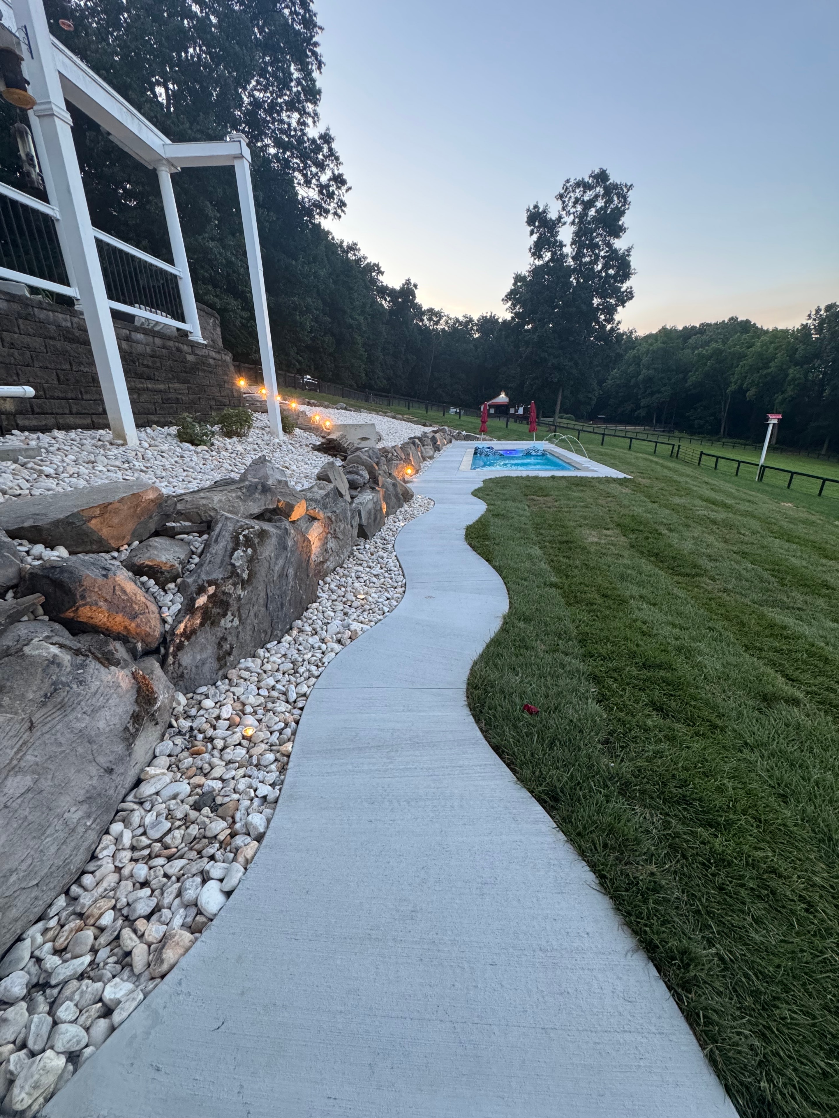 Hillside Retreat — patio and rock border at sunset