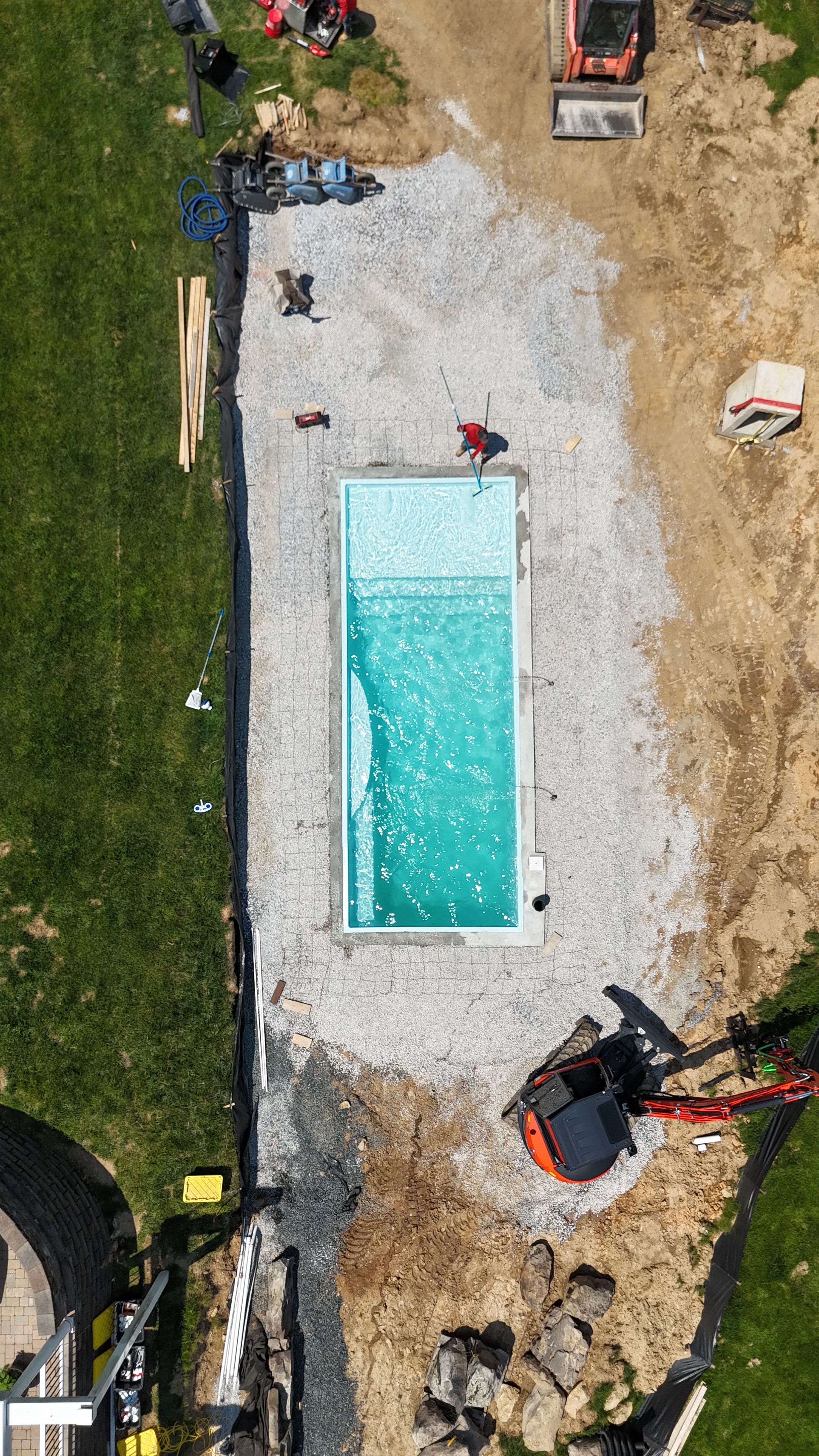 Under construction — aerial view of pool shell installed with equipment on site